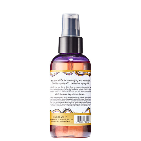 Back view of cylinder bottle with pump top and cap containing Franincense & Myrrh scented massage and body oil.