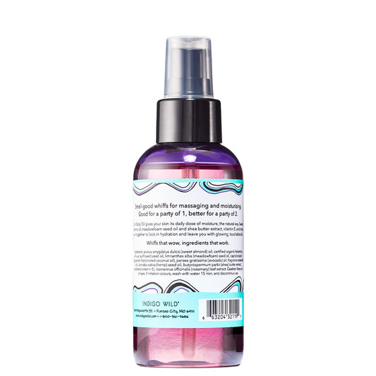 Back view of cylinder bottle with pump top and cap containing sea salt scented body oil