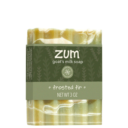 A 3 oz bar of Zum Goat's Milk Soap in the 'frosted fir' scent, wrapped in a dark olive green paper band with white lettering, set against a plain white background.