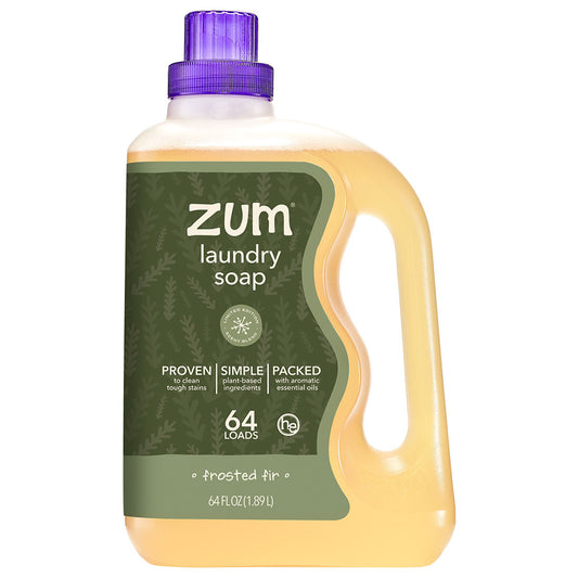 A 64 fl oz bottle of Zum Laundry Soap in frosted pine scent, featuring a translucent yellow liquid, a dark green label, and a purple cap, set against a plain white background.
