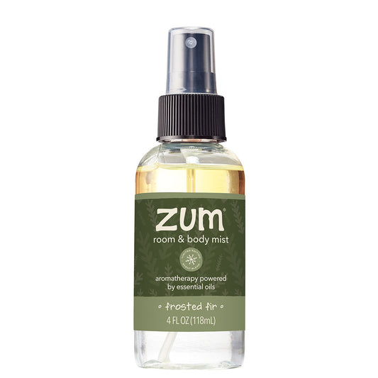 A 4 fl oz clear bottle of Zum Room & Body Mist in the 'Frosted Air' scent, featuring a dark olive green label and a black spray nozzle, set against a plain white background.