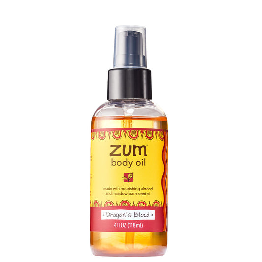Cylinder bottle with pump and lid containing dragon's blood infused massage and body oil.