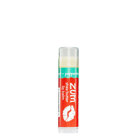 0.15 tube stick of Zumbo Kiss shea butter lip balm in the flavor Peppermint. Label colors are red and seafoam green.
