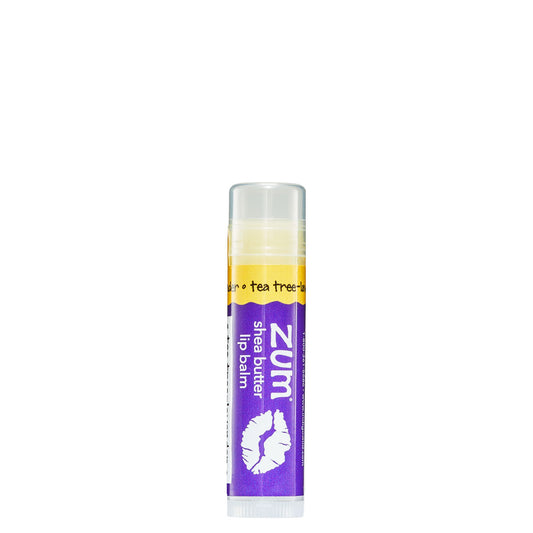 0.15 tube stick of Zumbo Kiss shea butter lip balm in the flavor Tea Tree-Lavender. Label colors are purple and yellow.