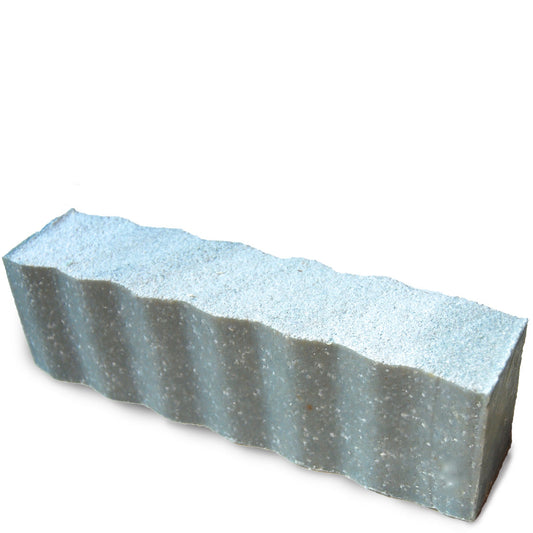 Light blue colored and speckled with sea salt wavy rectangular 45 ounce brick of citrus scented Zum Bar Soap