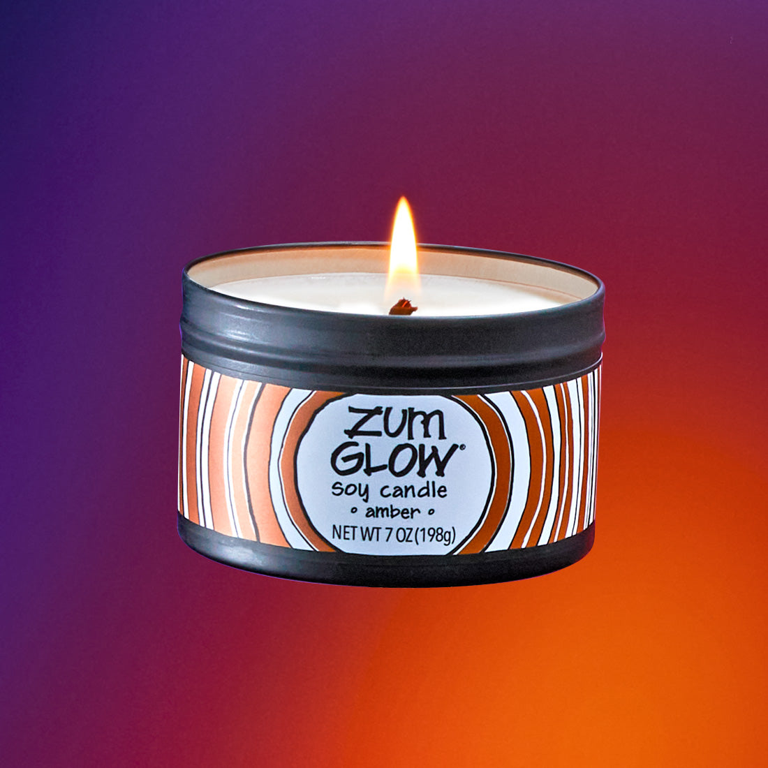 A lit labeled soy candle in a black tin flying in the air. Purple to orange gradient background.