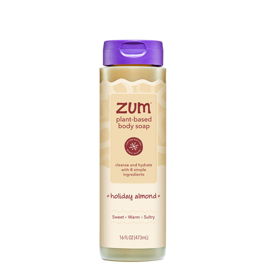 A 16 fl oz bottle of Zum Plant-Based Body Soap in Holiday Almond scent, featuring a beige label with wavy patterns, a purple flip-top cap, and a white base, shown on a solid white background.
