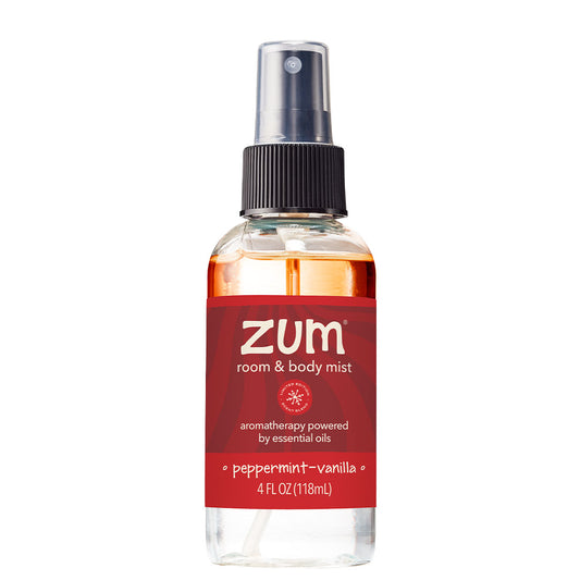 A clear room and body mist bottle with a black spray cap and a red label reading 'zum room & body mist' and 'peppermint-vanilla'.