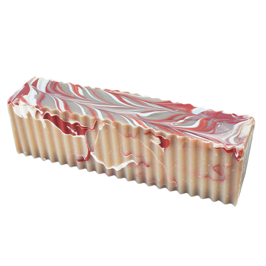 Tan, white, and red swirled soap brick with wavy edges.