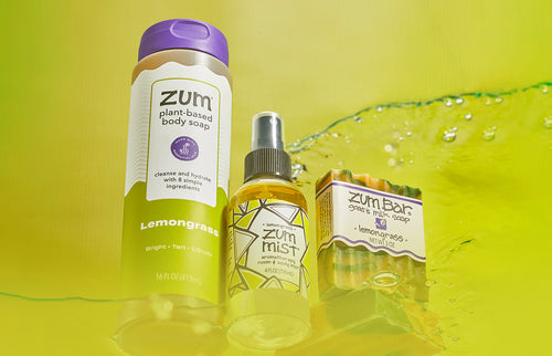 Lavender Zum Mist on blue background with water at bottom.