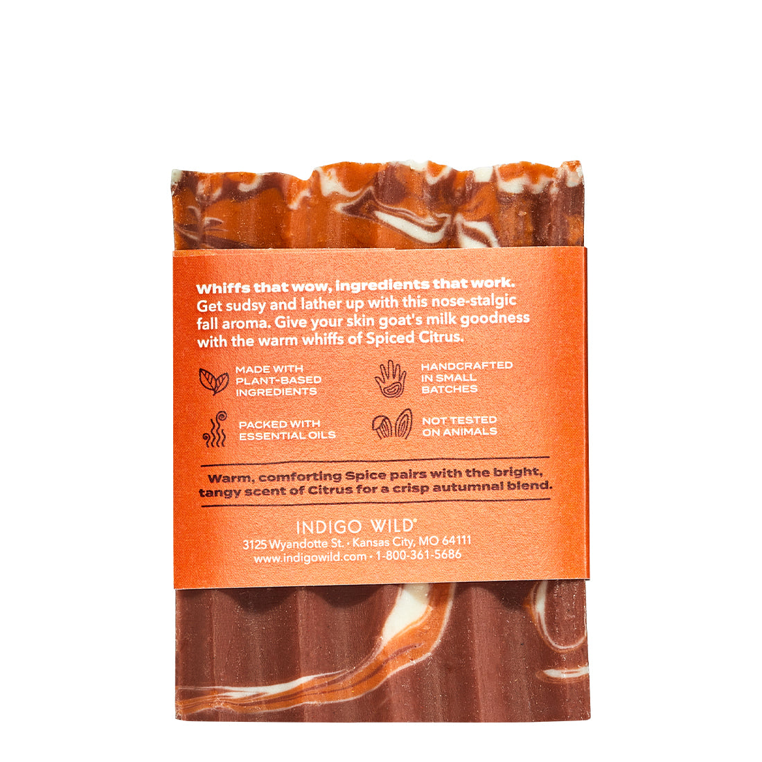 Back of Zum spiced citrus goat's milk soap bar with orange and brown packaging on a white background