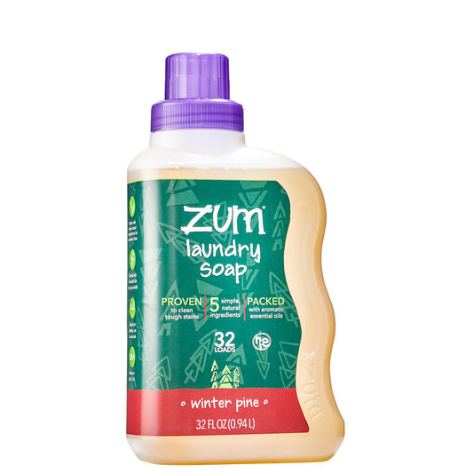 Clear Zum Laundry Soap bottle with liquid soap inside wrapped in a green winter pine label.