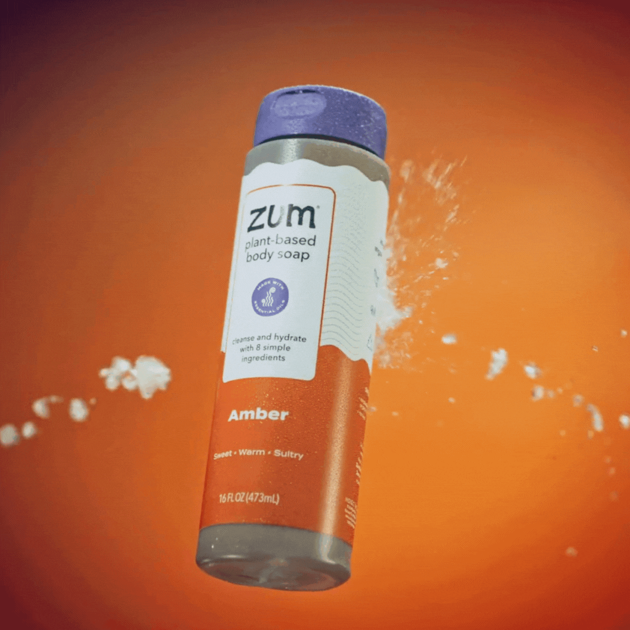 Amber Body Soap Bottle spinning in air with water hitting it.