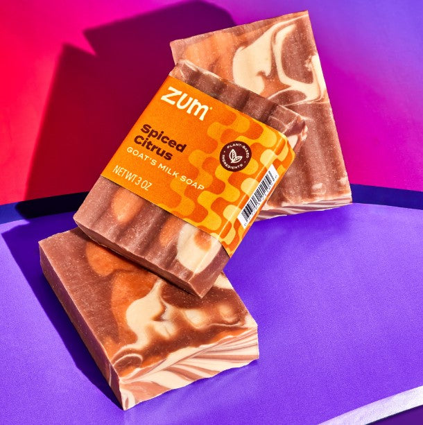 Marble-patterned soap bars with 'Zum' label on a colorful background