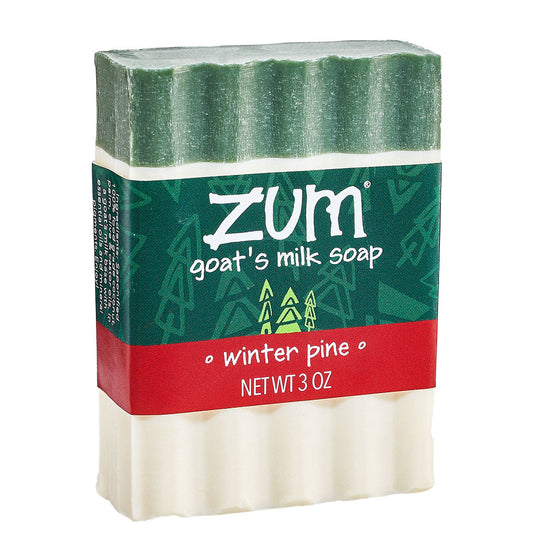 Front Shot of Zum Winter Pine Goat's Milk Soap. White Bar with green streak at top with label.